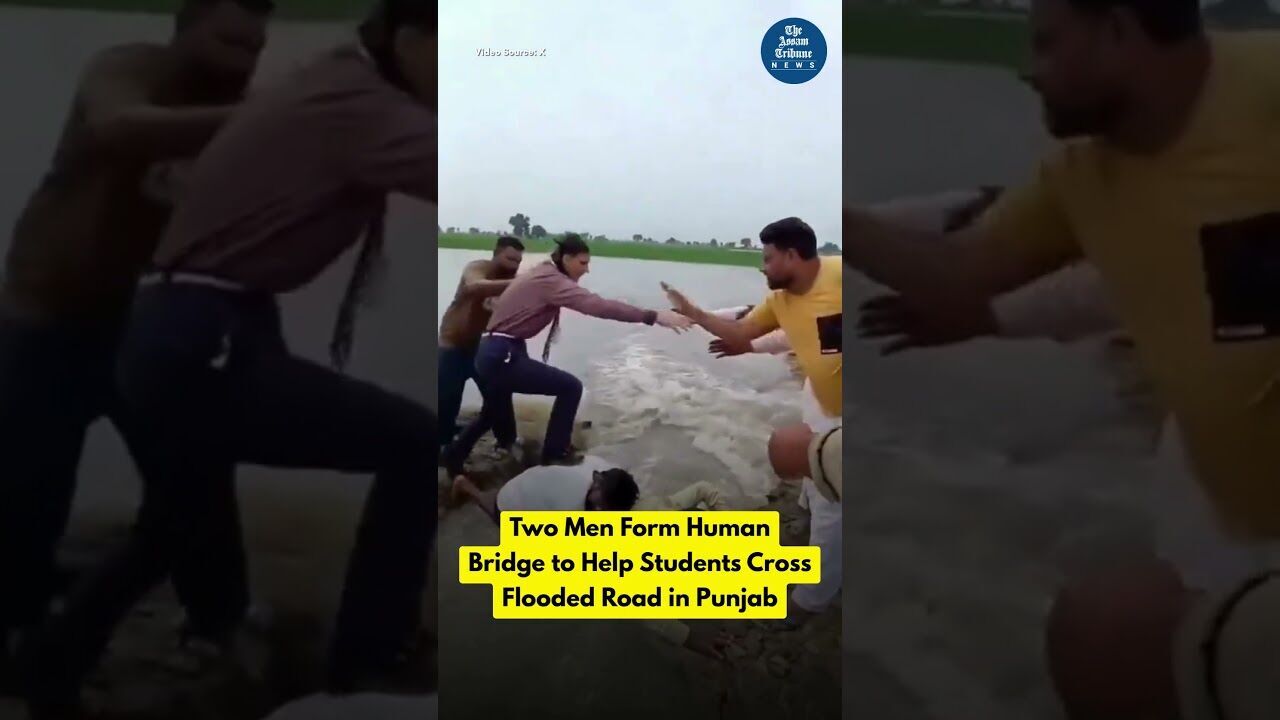 Two Men Form Human Bridge to Help Students Cross Flooded Road in Punjab